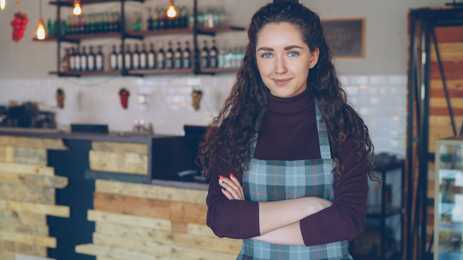 A Tampa Bay restaurant owner standing proudly in her business